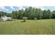 Expansive backyard with a full fence, outbuildings, and lush green grass provides ample space for outdoor activities at 37 Faithful Dr, Temple, GA 30179