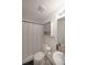 Bathroom featuring a shower with curtain, toilet, single sink vanity, and tile flooring at 37 Faithful Dr, Temple, GA 30179