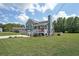 Blue two-story home with well-manicured front lawn, front porch, and driveway on a sunny day at 37 Faithful Dr, Temple, GA 30179