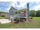 Well-maintained two-story home with a front porch, landscaped yard, and driveway on a bright day at 37 Faithful Dr, Temple, GA 30179