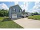 Inviting blue two-story home featuring a one-car garage, covered porch, and a well-kept lawn at 37 Faithful Dr, Temple, GA 30179