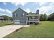 Charming blue two-story home with a cozy front porch and well-maintained lawn on a sunny day at 37 Faithful Dr, Temple, GA 30179