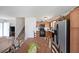 Functional eat-in kitchen with warm wooden cabinets and modern appliances, adjacent to living area and stairs at 37 Faithful Dr, Temple, GA 30179
