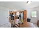 Bright eat-in kitchen with wood cabinets, neutral backsplash, and door to backyard at 37 Faithful Dr, Temple, GA 30179