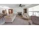 Comfortable living room featuring a stone fireplace, ceiling fan, plush seating, and natural light at 37 Faithful Dr, Temple, GA 30179
