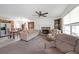 Spacious living room with a fireplace, ceiling fan, carpet, and comfortable seating, flowing into dining area at 37 Faithful Dr, Temple, GA 30179
