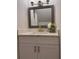 Bathroom features modern lighting, hammered-metal-look mirror and quartz countertop at 5685 Kingsport Dr, Sandy Springs, GA 30342