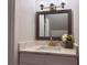 Bathroom features modern lighting, hammered-metal-look mirror and quartz countertop at 5685 Kingsport Dr, Sandy Springs, GA 30342