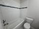 Modern bathroom with white subway tile and updated fixtures with shower and tub at 5685 Kingsport Dr, Sandy Springs, GA 30342