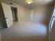 Neutral bedroom features soft carpet, window and white door with casing and baseboard at 5685 Kingsport Dr, Sandy Springs, GA 30342