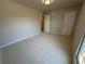 This carpeted bedroom features a window and two doors at 5685 Kingsport Dr, Sandy Springs, GA 30342