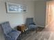 Cozy sitting area features modern decor, luxury vinyl plank flooring and lots of light at 5685 Kingsport Dr, Sandy Springs, GA 30342