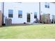 Spacious backyard with a well-maintained lawn and a view of the home's exterior at 5790 Thornton Dr, Cumming, GA 30028