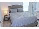 Cozy bedroom with a comfortable bed, gray headboard, and soft lighting at 5790 Thornton Dr, Cumming, GA 30028