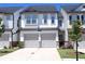Charming townhome with a two-car garage, a well-manicured lawn, and gray and white accents at 5790 Thornton Dr, Cumming, GA 30028