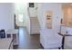 Bright foyer with wood floors, staircase, and a glimpse into the comfortable living room and powder room at 5790 Thornton Dr, Cumming, GA 30028