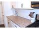 Kitchen featuring granite countertops, white cabinetry, a subway tile backsplash, and gas range at 5790 Thornton Dr, Cumming, GA 30028