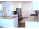 Modern kitchen features granite countertops, stainless steel appliances, and ample white cabinetry at 5790 Thornton Dr, Cumming, GA 30028