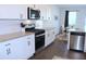 Well-equipped kitchen featuring stainless steel appliances, white cabinetry, and granite countertops at 5790 Thornton Dr, Cumming, GA 30028