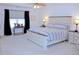 Inviting bedroom with a rustic bed, neutral décor, and plenty of natural light at 5790 Thornton Dr, Cumming, GA 30028