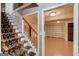 View of finished basement, stairs, and carpet in entry with beautiful wainscotting at 3898 Bay Creek Rd, Loganville, GA 30052