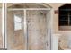 Tiled bathroom walk-in shower featuring glass doors, showerhead and a built-in shelf at 3898 Bay Creek Rd, Loganville, GA 30052