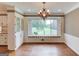 Dining room with window seat, hardwood floors, and built-in shelving at 3898 Bay Creek Rd, Loganville, GA 30052