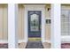 Elegant front door features decorative glass and hardware with white decorative columns and trim at 3898 Bay Creek Rd, Loganville, GA 30052
