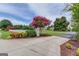 Inviting entrance with flowering trees, a white picket fence, and lush landscaping at 3898 Bay Creek Rd, Loganville, GA 30052