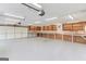 Spacious garage features built-in shelving, overhead lighting, and a large roll-up door at 3898 Bay Creek Rd, Loganville, GA 30052