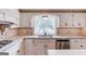 Traditional kitchen with stainless steel appliances, backsplash, and window view at 3898 Bay Creek Rd, Loganville, GA 30052