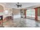 Living room features a fireplace, slate floors, and large windows with decorative curtains at 3898 Bay Creek Rd, Loganville, GA 30052