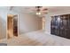 Large main bedroom featuring a ceiling fan, double doors, carpet and an ensuite bathroom at 3898 Bay Creek Rd, Loganville, GA 30052