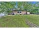 Spacious front yard featuring a cozy house and mature trees at 5400 Kings Camp Rd Se #C1 Se Rd, Acworth, GA 30102