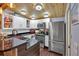 Well-lit kitchen with stainless steel appliances, white cabinetry, and wood ceiling at 5400 Kings Camp Rd Se #C1 Se Rd, Acworth, GA 30102