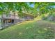 Backyard view with a deck, screen porch, and a sloping lawn at 6790 India Ln, Cumming, GA 30041