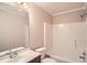 Bright bathroom with a single sink vanity, toilet, and a shower-tub combination at 6790 India Ln, Cumming, GA 30041
