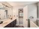 Large bathroom with double vanity sinks and combination shower/tub at 6790 India Ln, Cumming, GA 30041