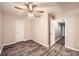 Bedroom with wood-look flooring, ceiling fan, and a doorway leading to another room at 6790 India Ln, Cumming, GA 30041