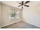 Cozy bedroom with neutral paint, carpeted floor, a window, and a ceiling fan at 6790 India Ln, Cumming, GA 30041