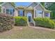 Charming front exterior with stone accents, a well-manicured lawn, and lush landscaping at 6790 India Ln, Cumming, GA 30041