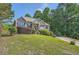 Inviting front exterior showcasing a well-kept lawn, mature trees, and a cozy home design at 6790 India Ln, Cumming, GA 30041