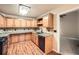 Well-lit kitchen with wood cabinets, dark countertops and backsplash, and stainless steel appliances at 6790 India Ln, Cumming, GA 30041