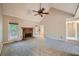 Comfortable living room showcasing vaulted ceilings, fireplace, and neutral carpeting at 6790 India Ln, Cumming, GA 30041