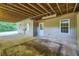A covered patio area with a concrete slab floor and access to the backyard at 6790 India Ln, Cumming, GA 30041