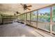 Screened porch featuring multiple ceiling fans, and a view of the house on the hillside at 6790 India Ln, Cumming, GA 30041