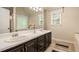 Bathroom featuring double sinks, modern fixtures, wood vanity, and decorative accents at 90 Camden Woods Pl, Dallas, GA 30157