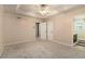 Neutral bedroom with ensuite, featuring plush carpet, ceiling fan, closet, and neutral walls at 90 Camden Woods Pl, Dallas, GA 30157