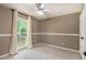 Bedroom featuring a ceiling fan, neutral walls, plush carpet, and natural light streaming through a large window at 90 Camden Woods Pl, Dallas, GA 30157