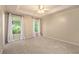Bright bedroom featuring a trey ceiling, neutral walls, plush carpet, and natural light streaming through two windows at 90 Camden Woods Pl, Dallas, GA 30157